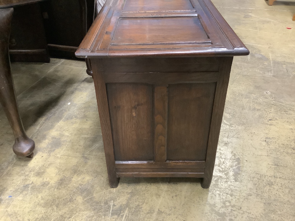 An 18th century style carved oak panelled coffer, width 105cm depth 45cm height 58cm